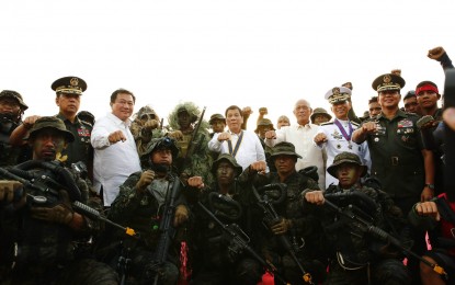 <p><strong>RAID SIMULATION.</strong> President Rodrigo Roa Duterte strikes his signature pose with the personnel of the Naval Special Operations Group and the Marine Special Operations Group after they conducted a raid simulation before President Rodrigo Roa Duterte during the Philippine Navy's 120th anniversary at the Coconut Palace of the Cultural Center of the Philippines (CCP) Complex in Roxas Boulevard, Manila on May 22, 2018 (Tuesday). Joining the president are Armed Forces of the Philippines (AFP) Chief of Staff General Carlito Galvez Jr., House Speaker Pantaleon Alvarez, Defense Secretary Delfin Lorenzana, Philippine Navy Commander Vice Admiral Robert Empredad and Philippine Army Commander Lieutenant General Rolando Bautista. <em>Rey Baniquet/Presidential Photo</em></p>